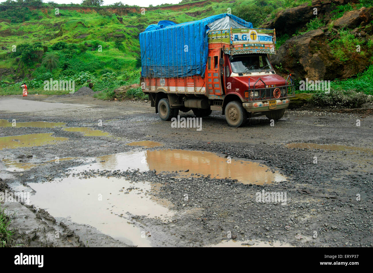 Truck takes treacherous journey in monsoon on Ghodbunder road in Thane ; Maharashtra ; India Stock Photo