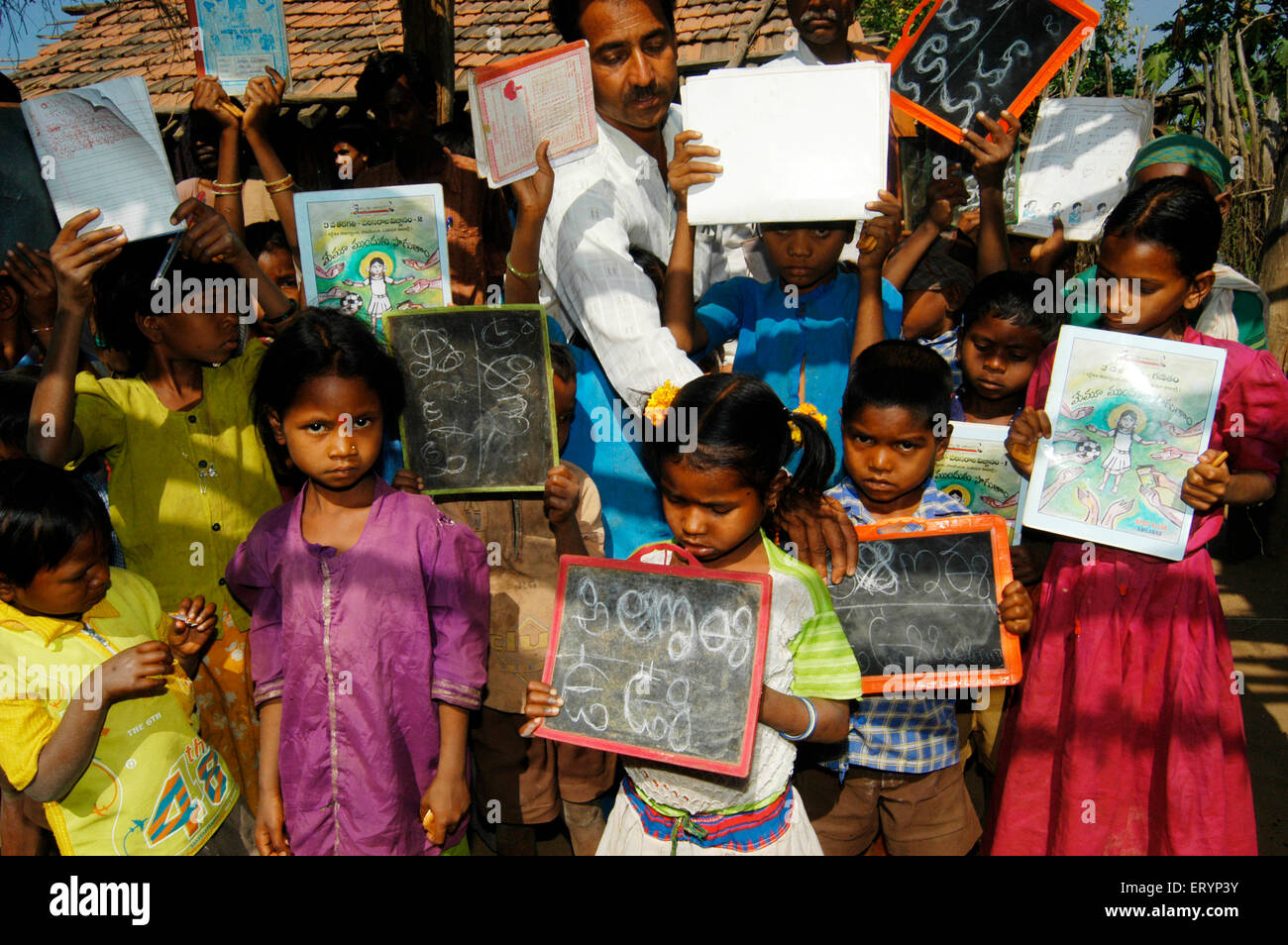 Tribal children learn Telugu alphabets in school run by NGO Non Government Organization in village at Andhra Pradesh India Stock Photo
