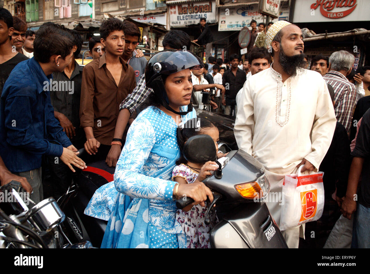 Annoyed mother driving two wheeler with her daughter stuck at traffic jam in Bombay Mumbai ; Maharashtra ; India NO MR Stock Photo
