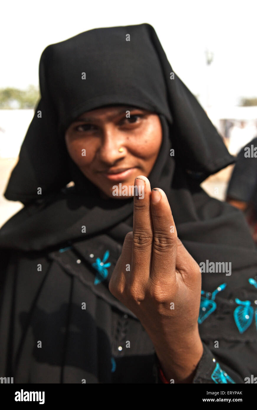 Muslim woman showing voting mark in elections ; Bombay Mumbai ; Maharashtra ; India NO MR 30 April 2009 Stock Photo