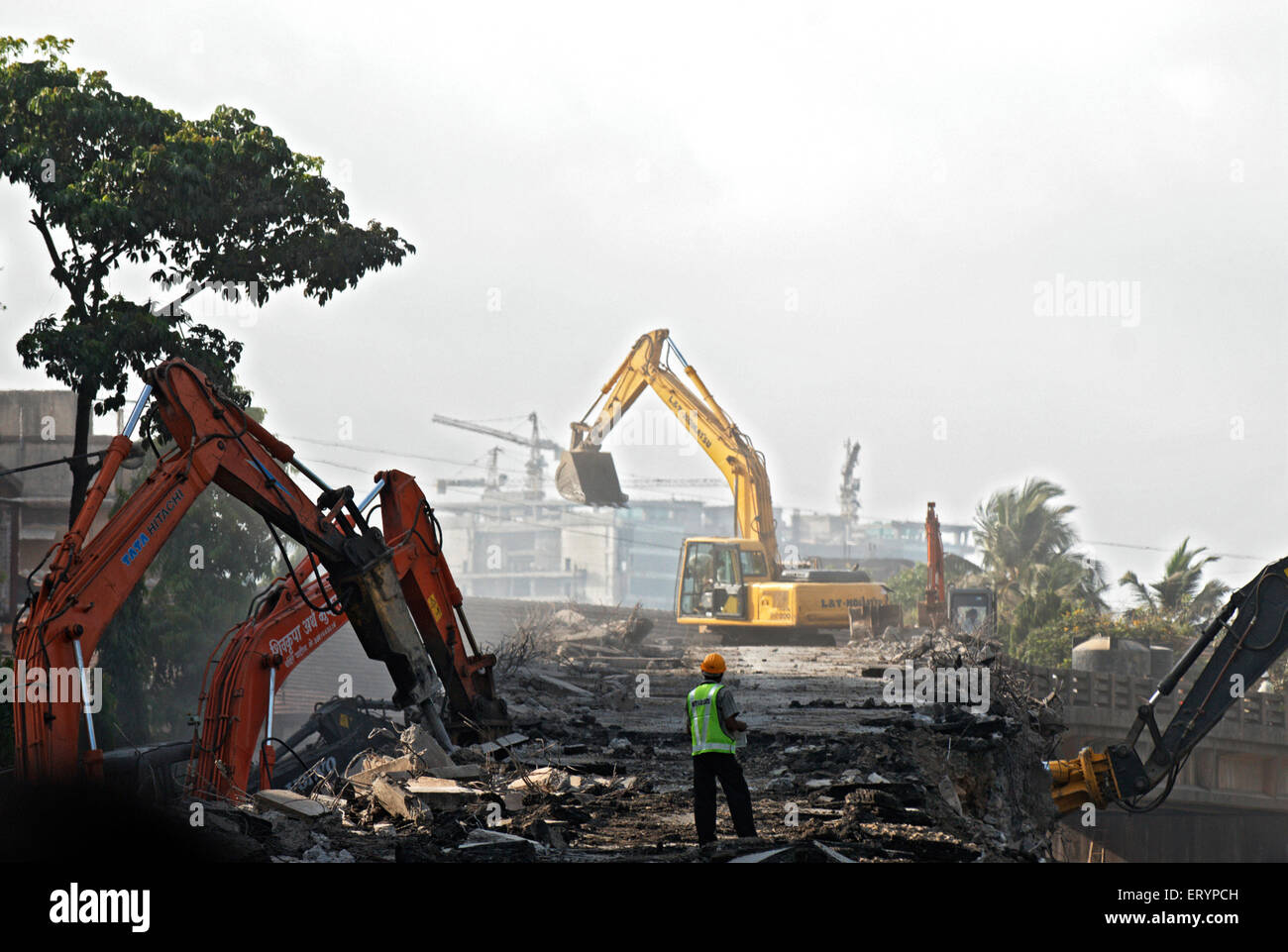 Workers demolishing lalbaug flyover using heavy machinery in Bombay Mumbai  ; Maharashtra  ; India 5 May 2009 Stock Photo