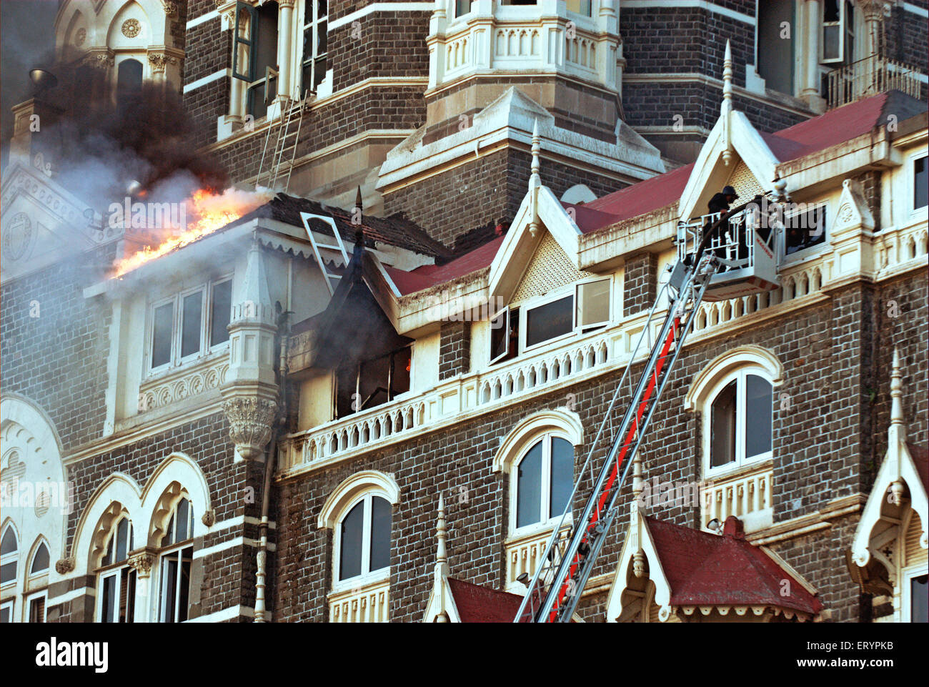 Fire fighters try to douse fire inside of Taj Mahal hotel after terrorist attack by deccan mujahedeen Mumbai Stock Photo