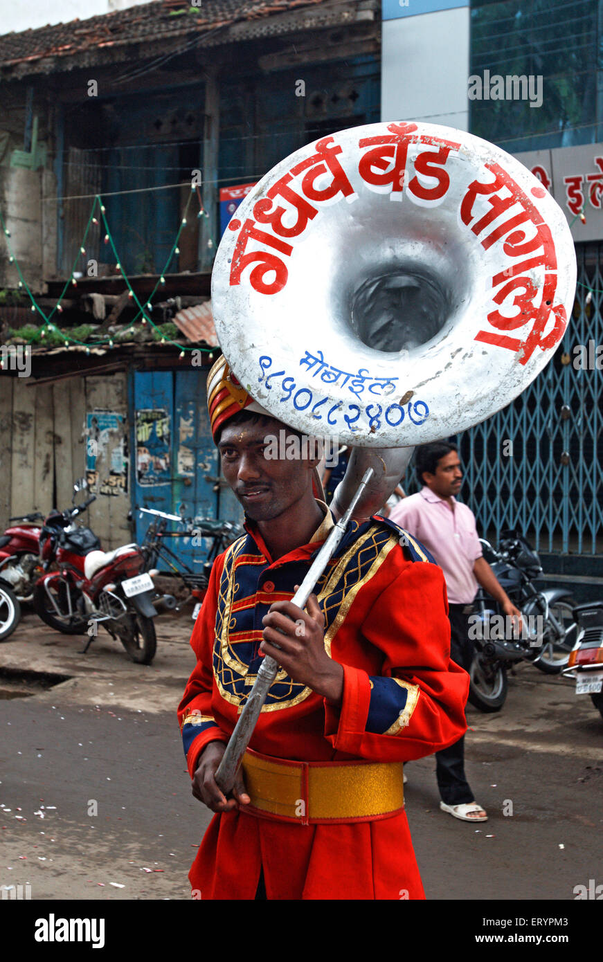 band musician carrying tuba musical instrument , Sangli ; Maharashtra ; India , asia Stock Photo