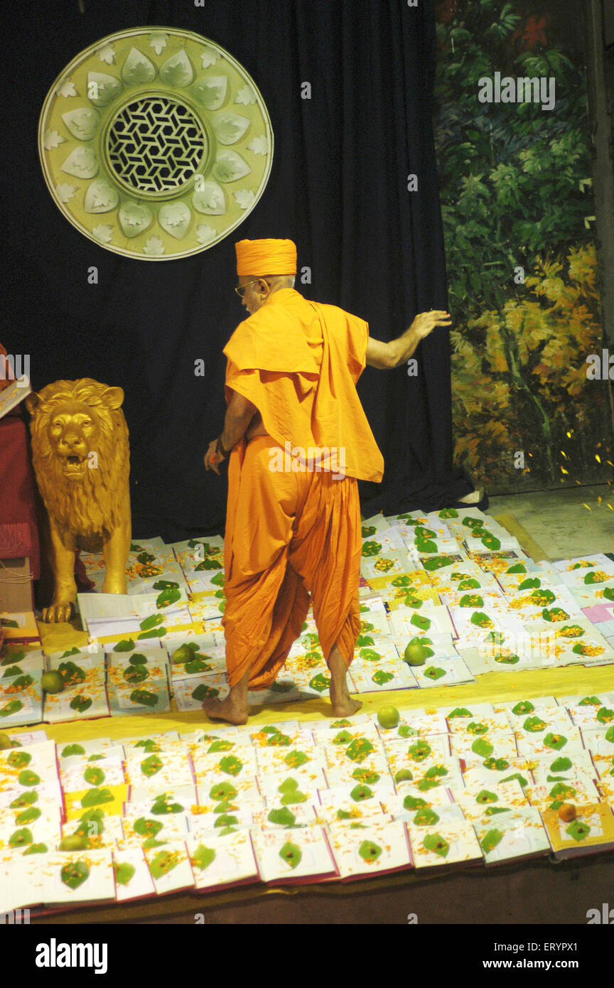 Swaminarayan priest performing chopadi puja ritual performed on lakshmi puja  ; Bombay Mumbai ; Maharashtra ; India Stock Photo