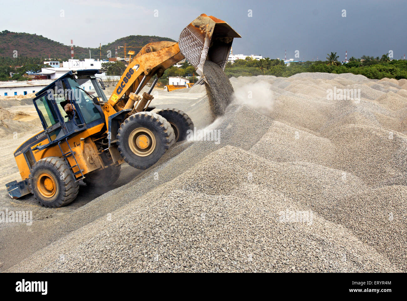 Excavator dumping crushed stones , Madras , Chennai ; Tamil Nadu ; India , Asia Stock Photo