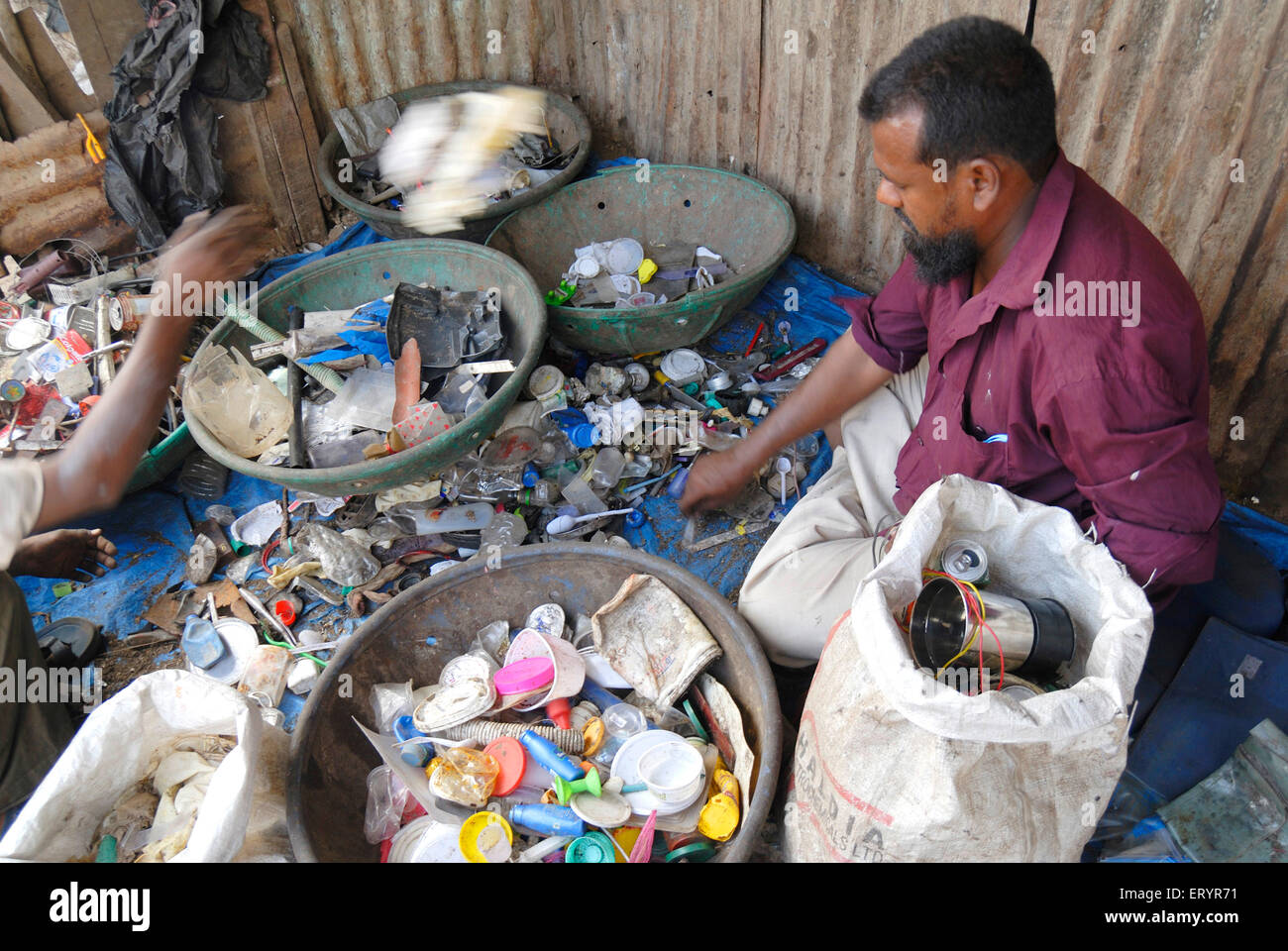 Scrap dealers sorting scrap , Landfill , waste dumping ground , Deonar , Bombay , Mumbai , Maharashtra , India , Asia Stock Photo
