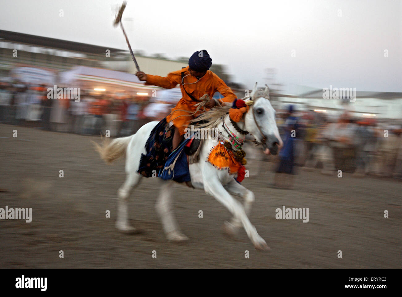 Nihang sikh warrior performing stunts in celebrations of consecration of sikh guru granth sahib ; Nanded Stock Photo