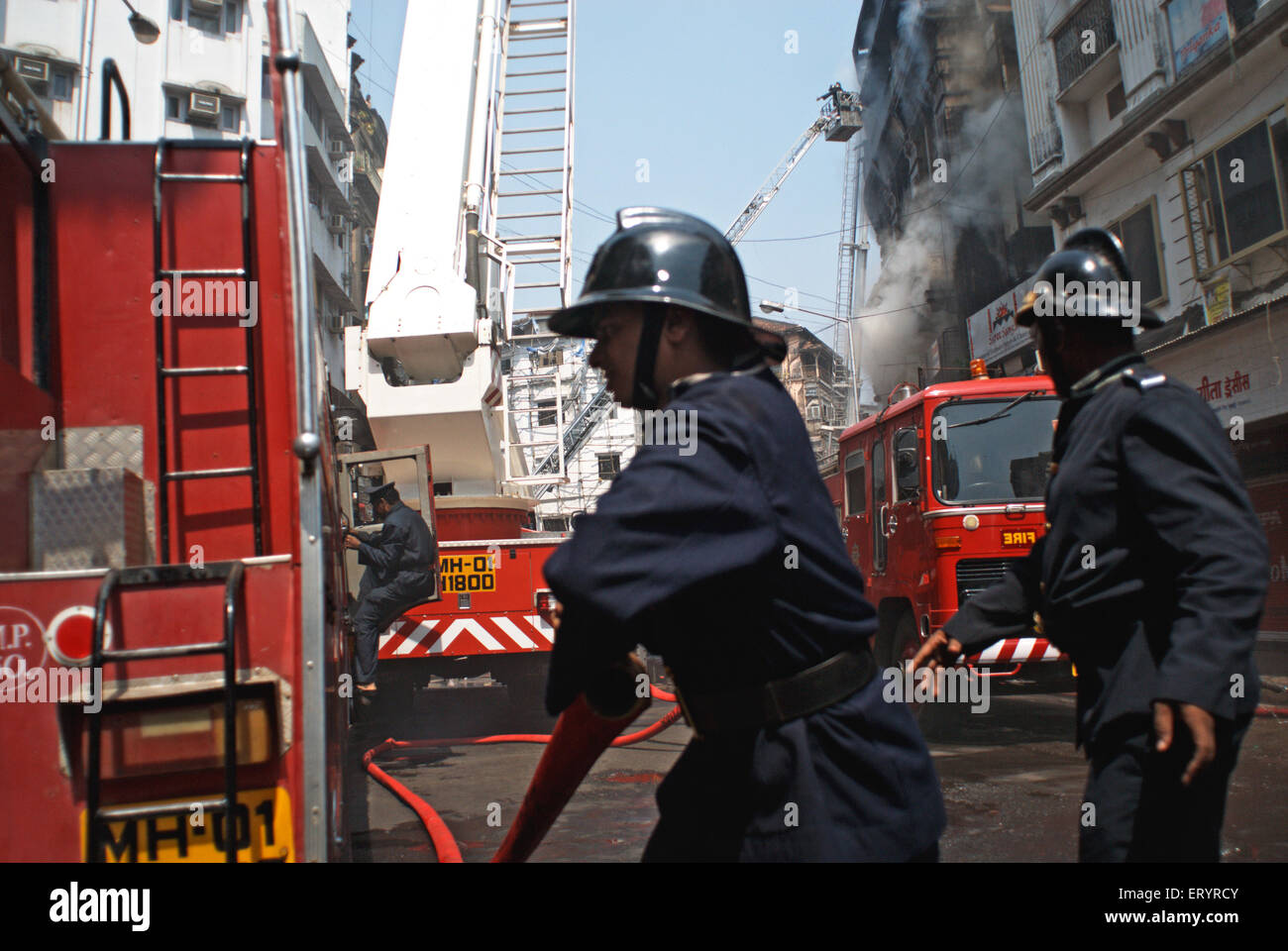 Firemen fighting fire in Johri Mansion, Kalbadevi, Bombay, Mumbai, Maharashtra, India, Asia Stock Photo