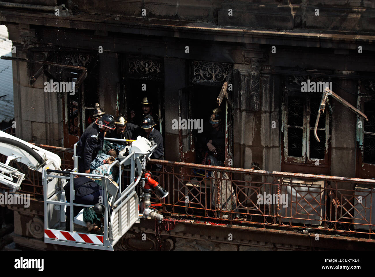 Fireman carrying dead body after fire in Johri Mansion at Kalbadevi ; Bombay Mumbai ; Maharashtra ; India 14 October 2008 Stock Photo