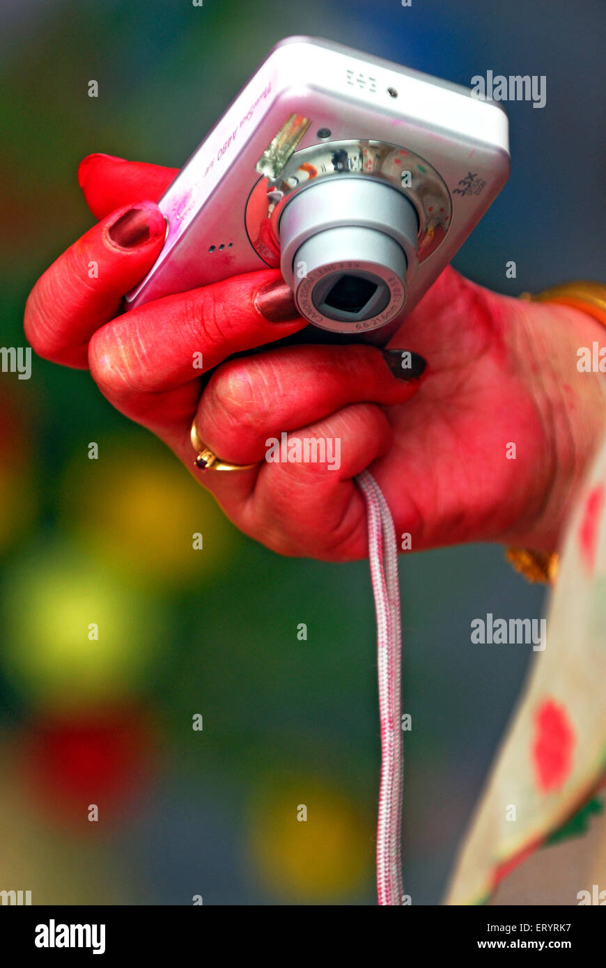 Woman holding digital camera , Stock Photo