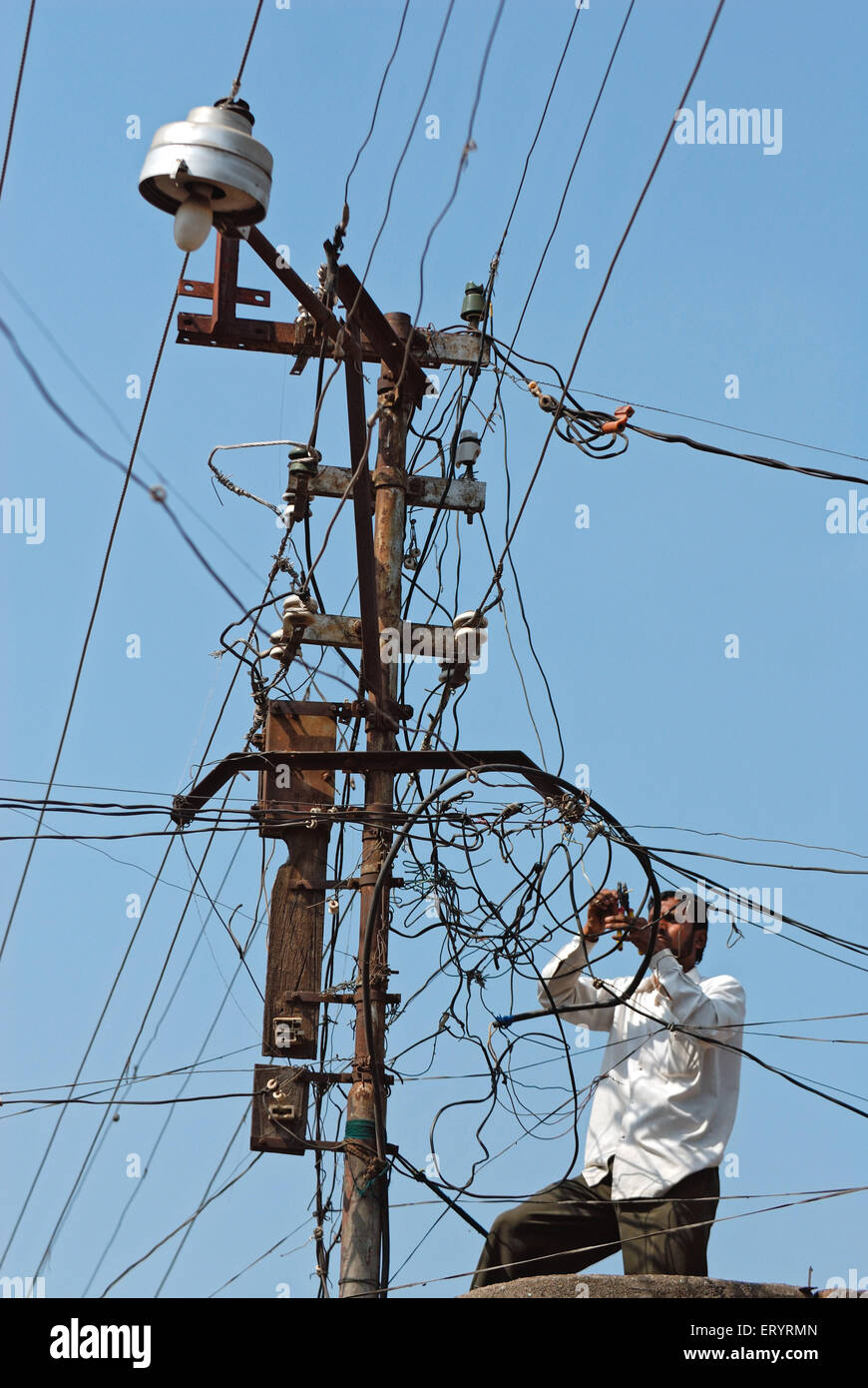 Electrician working on high tension electric wire ; Malegaon Stock Photo Alamy