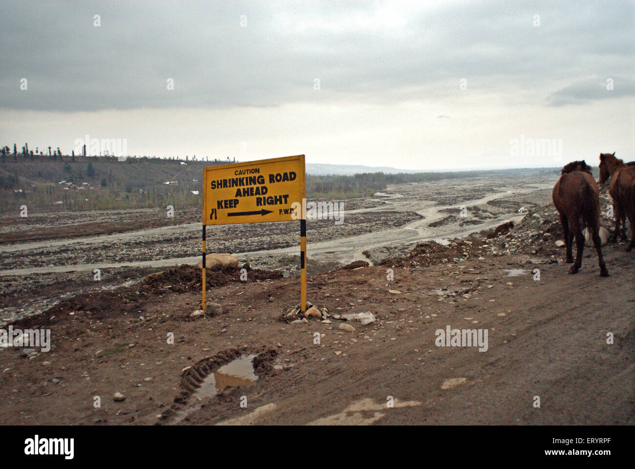 Shrinking road keep right signboard at under constructed site of mughal road ; Jammu and Kashmir ; India 8 April 2008 Stock Photo