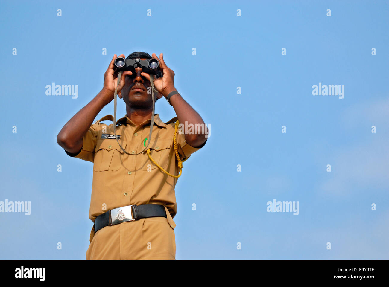 Policeman looking through binocular , India , Asia Stock Photo