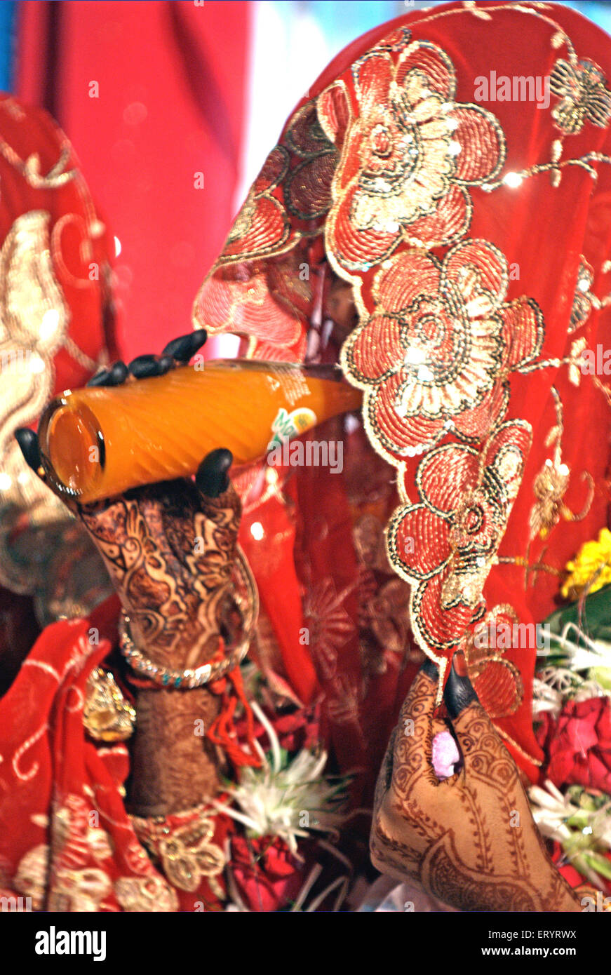 Muslim bride in veil drinking soft drink in marriage ceremony 15 June 2009 Stock Photo