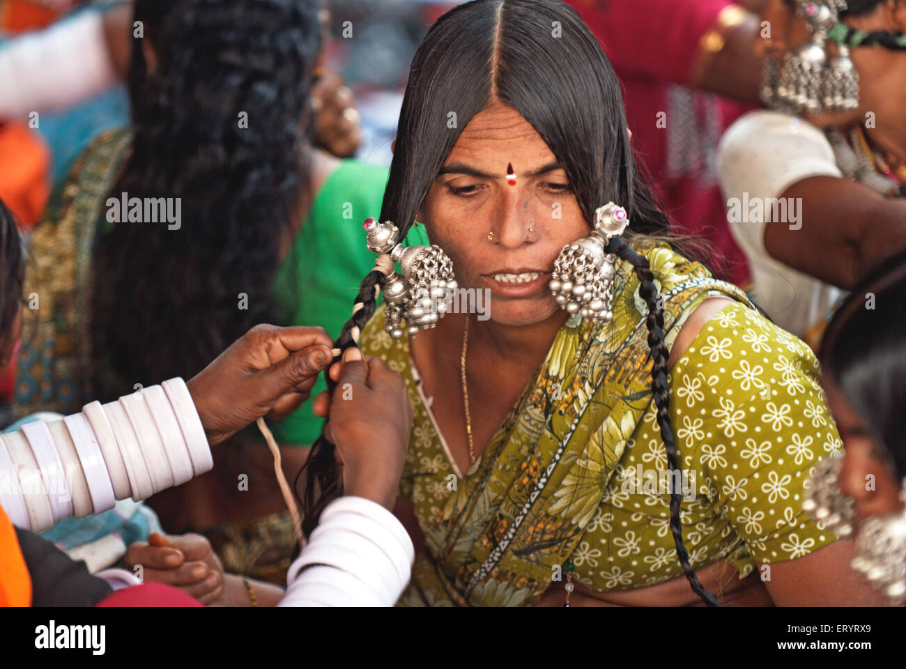 Banjara gypsy nomad tribal woman wearing silver hair jewelry , Nanded , Maharashtra , India , Asia Stock Photo