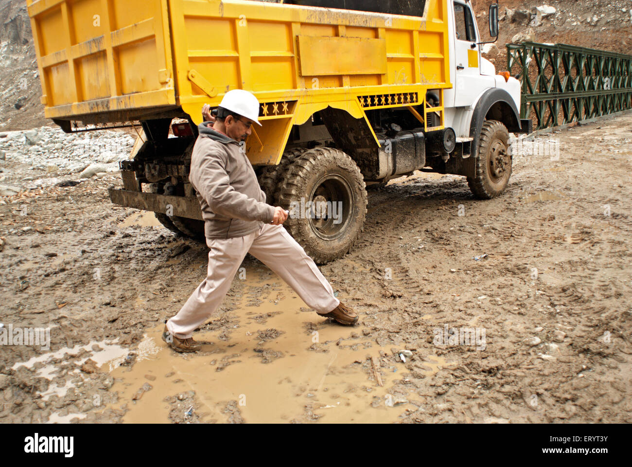 PWD officer near dumper truck crossing muddy mughal road ; Jammu and Kashmir ; India NO MR 8 April 2008 Stock Photo