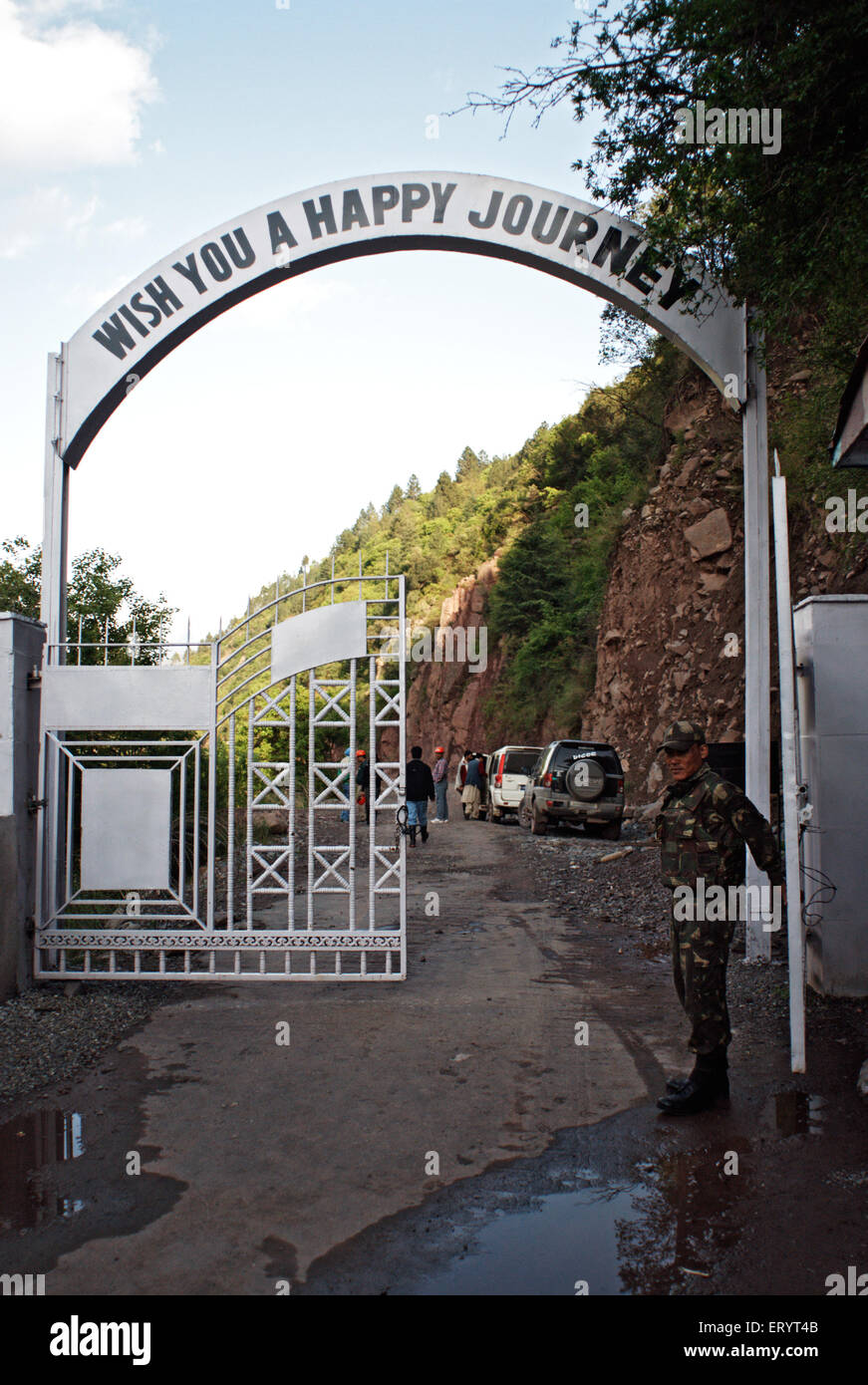 Happy journey on entry gate guarded by bsf soldier at Kamanpost ; Uri ; Jammu and Kashmir ; India 6 April 2008 Stock Photo