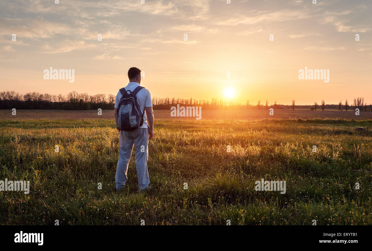 Silhouette of man with arms raised up and beautiful sky. Element of design. Summer sunset. Background Stock Photo