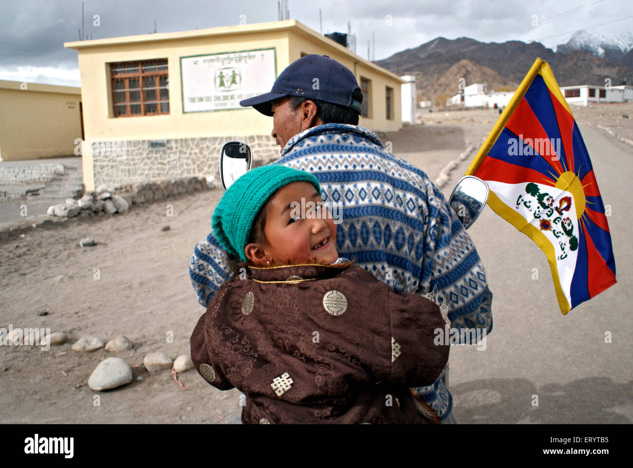 Man and son with tibetan flag ; Leh ; Ladakh ; Jammu and Kashmir ; India 11  April 2008 Stock Photo