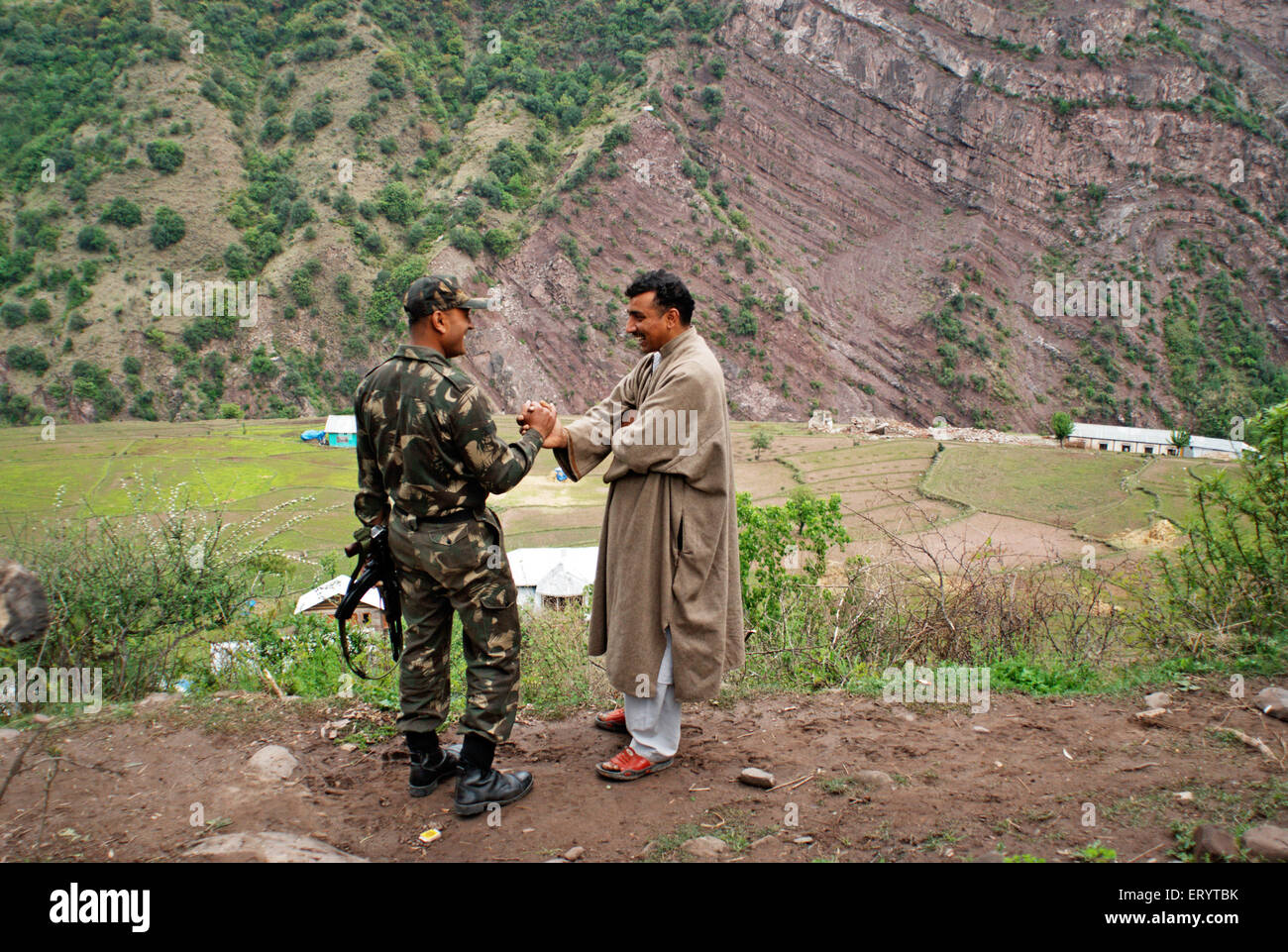 Border security force soldier with man of Urusa village ; Uri ; Jammu and Kashmir ; India  NO MR 7 April 2008 Stock Photo