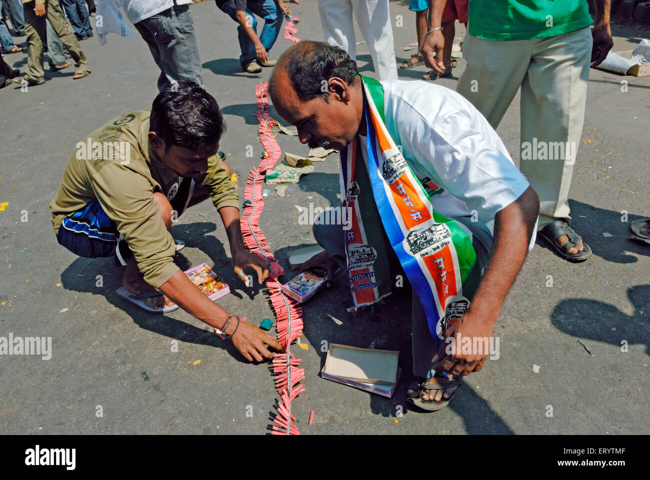 Indian elections , Man celebrating election victory bursting crackers , Maharashtra Navnirman Sena  supporter , Bombay , Mumbai , Maharashtra , India Stock Photo