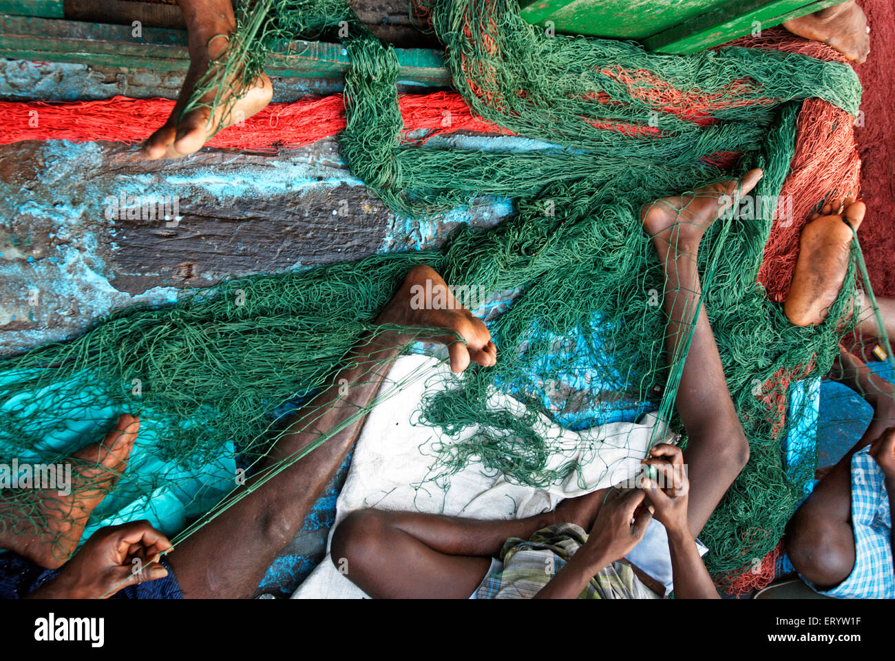 Fishermen repairing fishing nets , Kasimedu fish market , Royapuram fishing harbour , Madras , Chennai , Tamil Nadu , India , Asia Stock Photo
