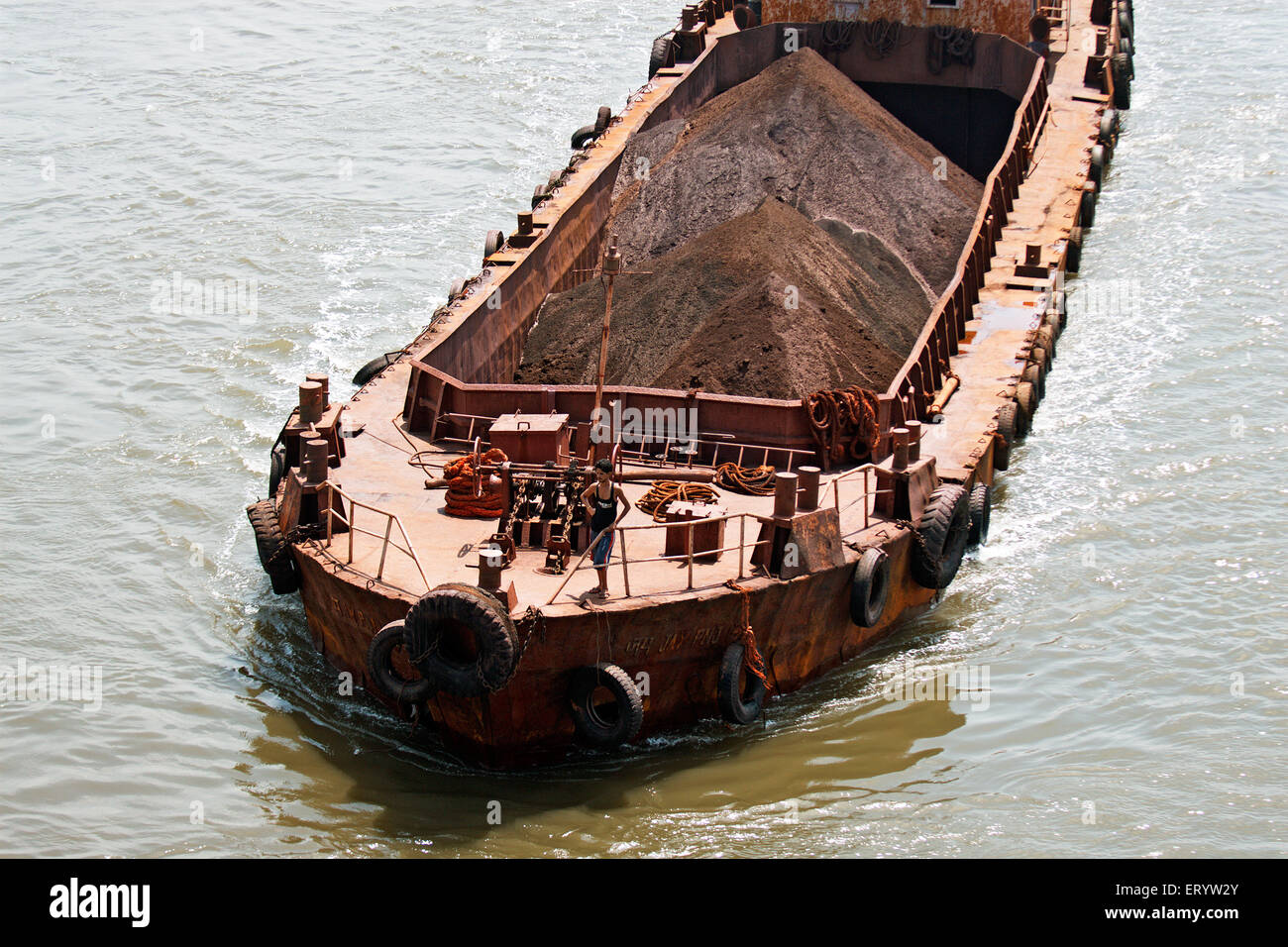 Barge , shoal draft flat bottomed boat transporting iron ore on Mandovi river , Panji , Panjim , Goa , India , Asia Stock Photo