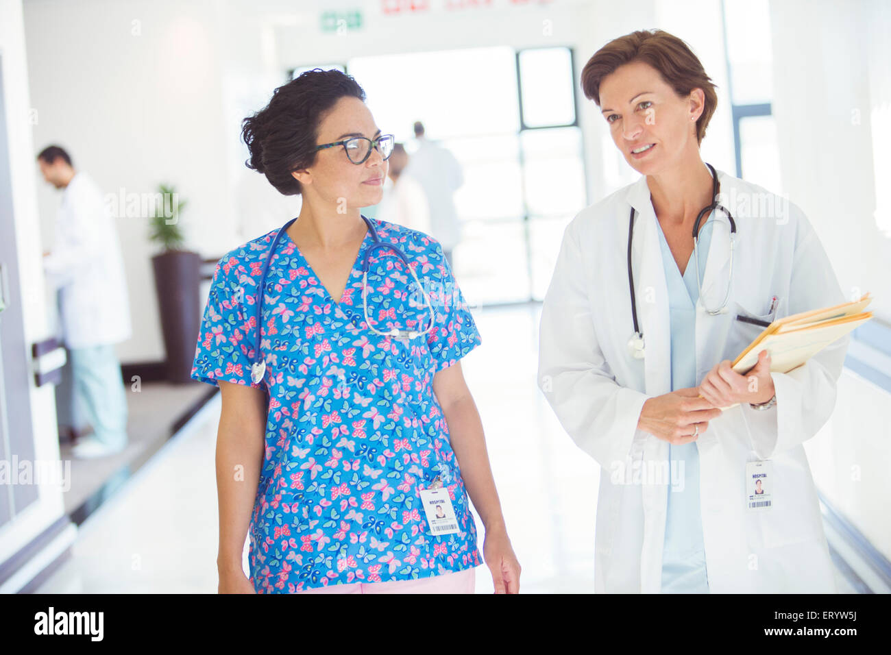 Doctor and nurse talking in hospital corridor Stock Photo