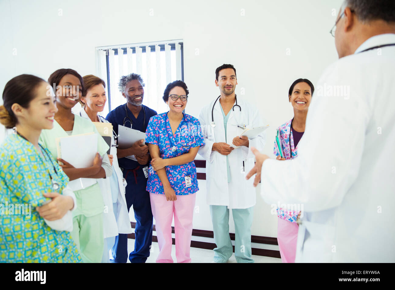 Doctor leading team meeting in hospital corridor Stock Photo