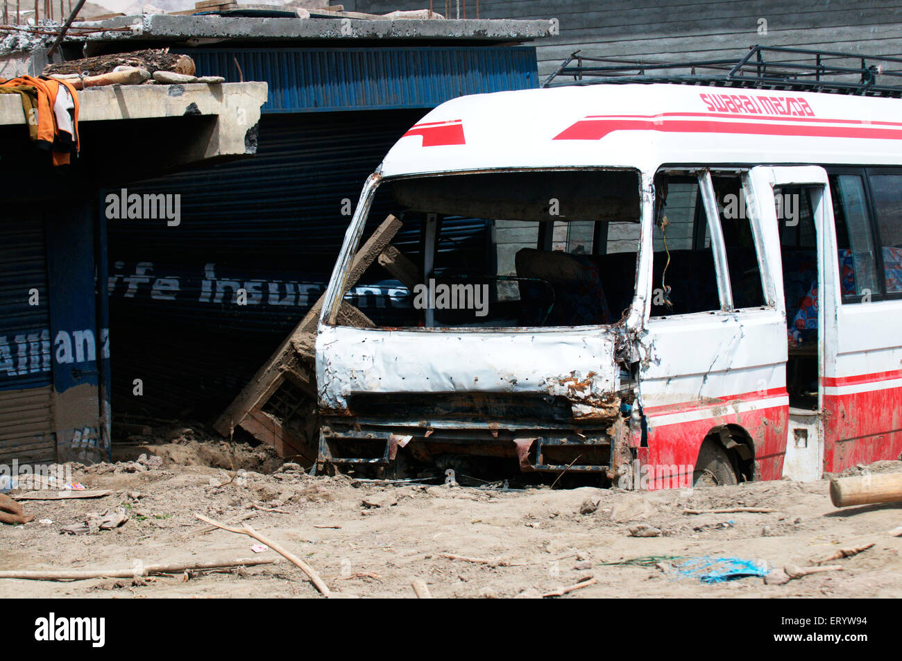 Damaged bus stuck in mud at choglamsar due to flashflood ; Leh ; Ladakh ; Jammu and Kashmir ; India Stock Photo