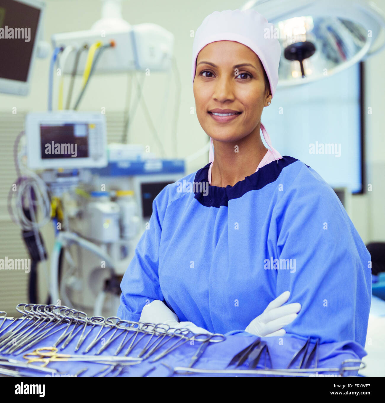 Portrait of confident surgeon near surgical scissors in operating room Stock Photo
