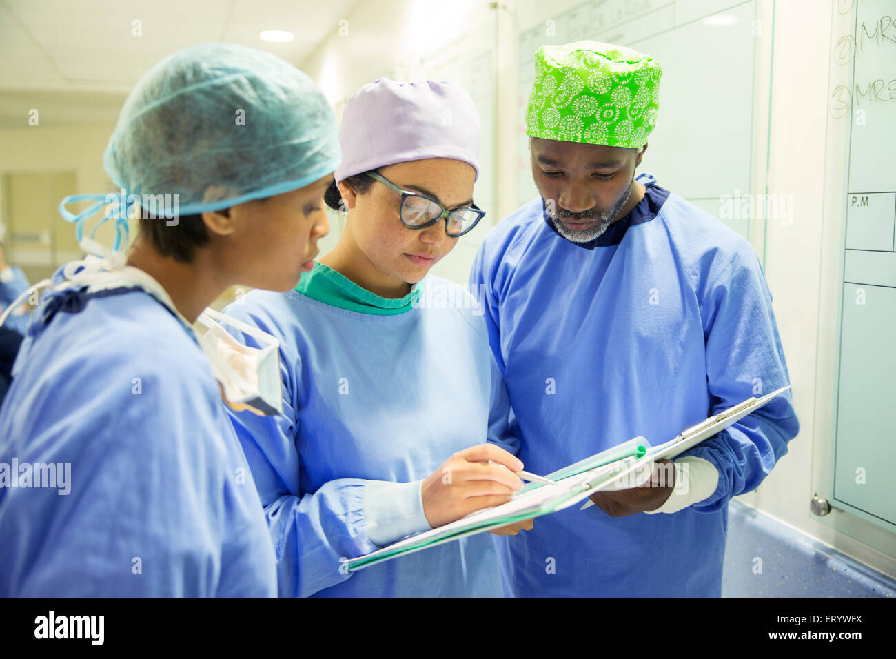 Surgeons reviewing medical record in hospital Stock Photo