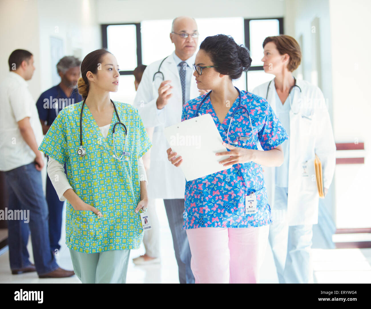 Nurses talking in hospital corridor Stock Photo