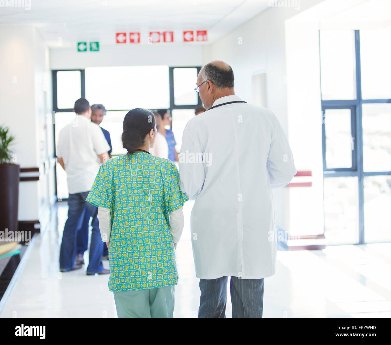 Doctor and nurse walking in hospital corridor Stock Photo