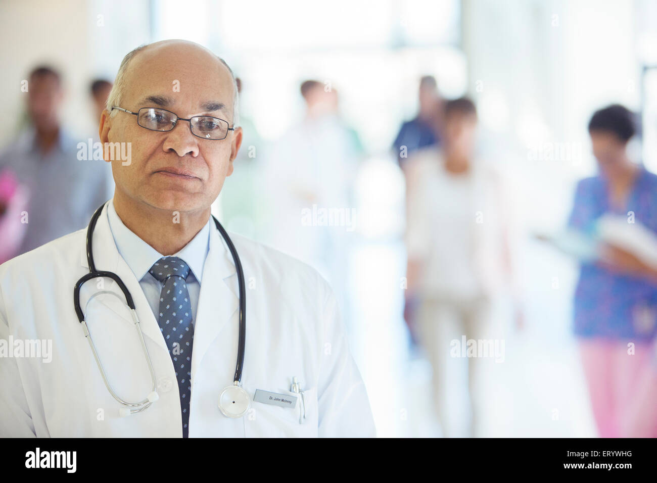 Portrait of confident doctor in hospital corridor Stock Photo