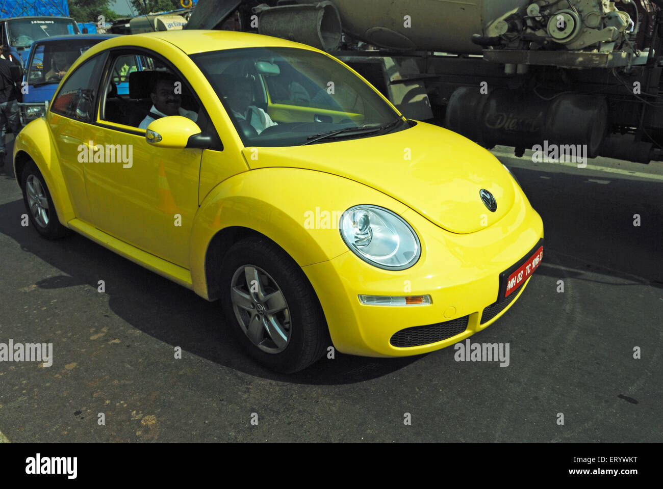 Volkswagen Beetle and Mini Cooper yellow car on road ; Bombay ; Mumbai  ; Maharashtra  ; India , Asia Stock Photo