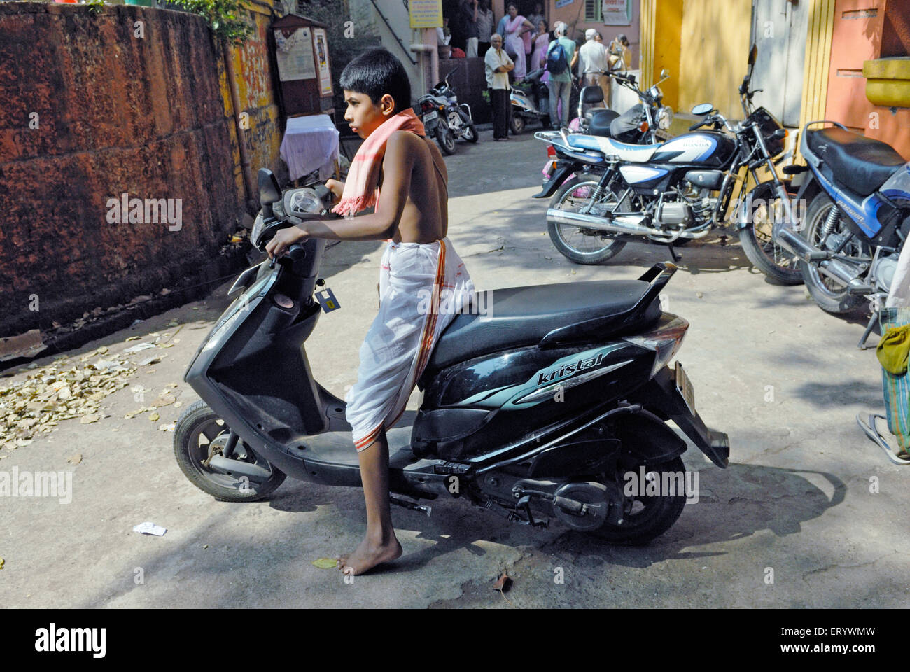 Child driving two wheeler  ; Kolhapur  ; Maharashtra  ; India NOMR Stock Photo