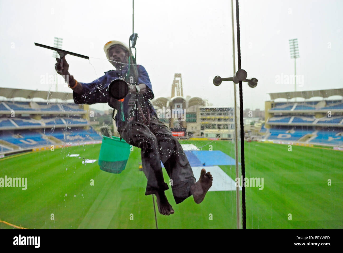 Glass cleaner at D Y Patil cricket stadium ; Nerul ; Navi Bombay Mumbai
