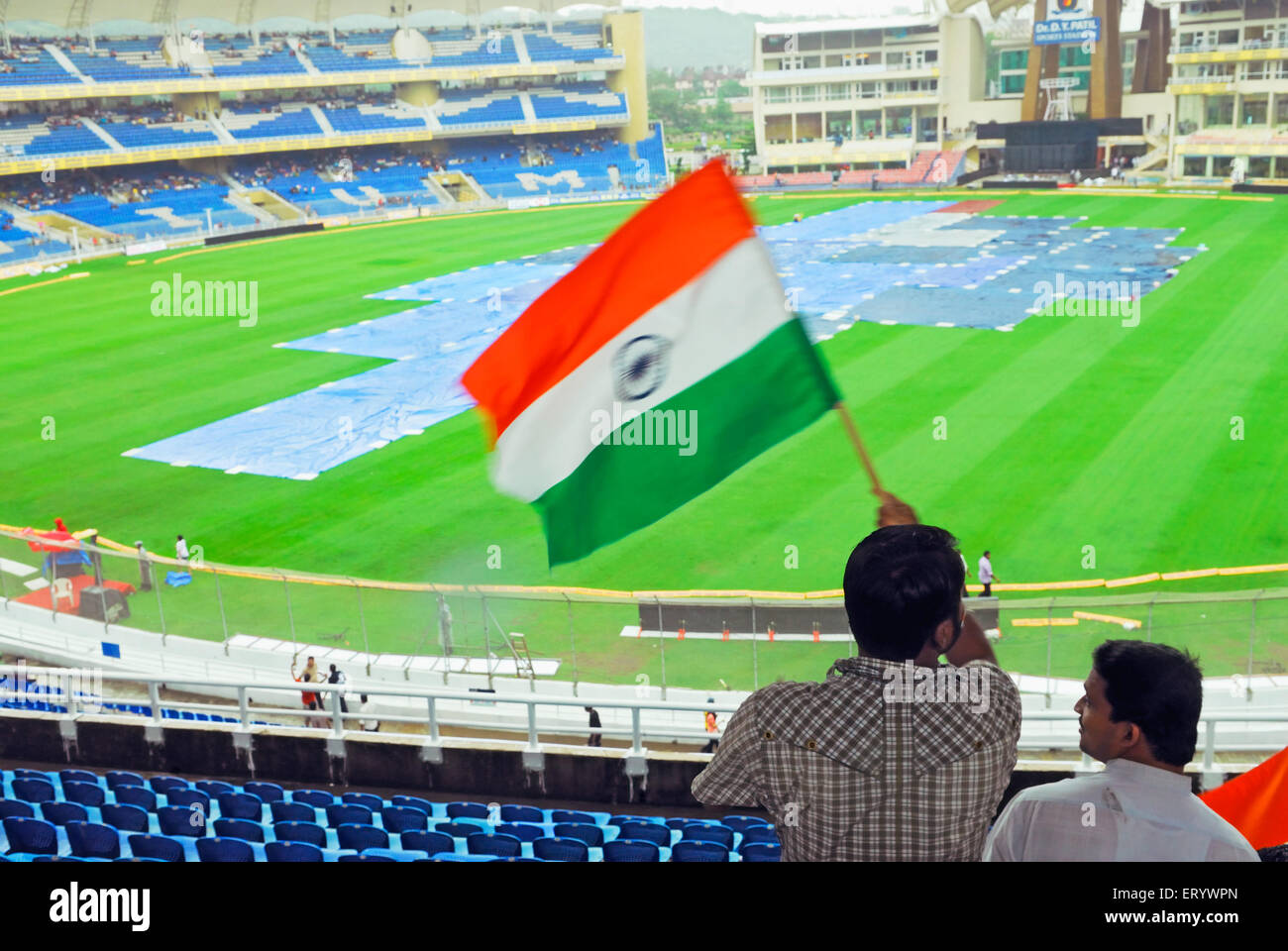 Cricket fans wave Indian flag at D Y Patil cricket stadium  ; Nerul  ; Navi Mumbai  ; Maharashtra  ; India Stock Photo