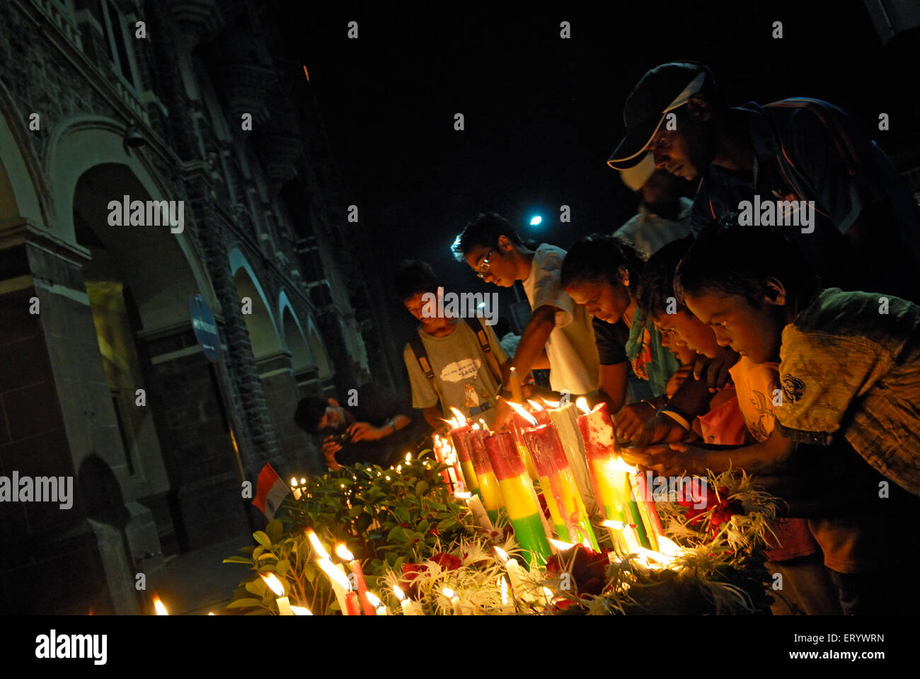 People lighting candles in memory of terror attack  ; Bombay ; Mumbai ; Maharashtra ; India NOMR Stock Photo