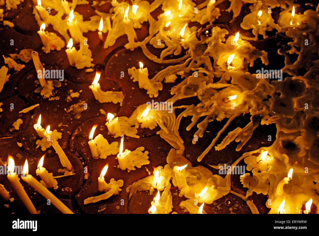 Lighting candles in memory of terror attack ; Bombay ; Mumbai ; Maharashtra ; India Stock Photo
