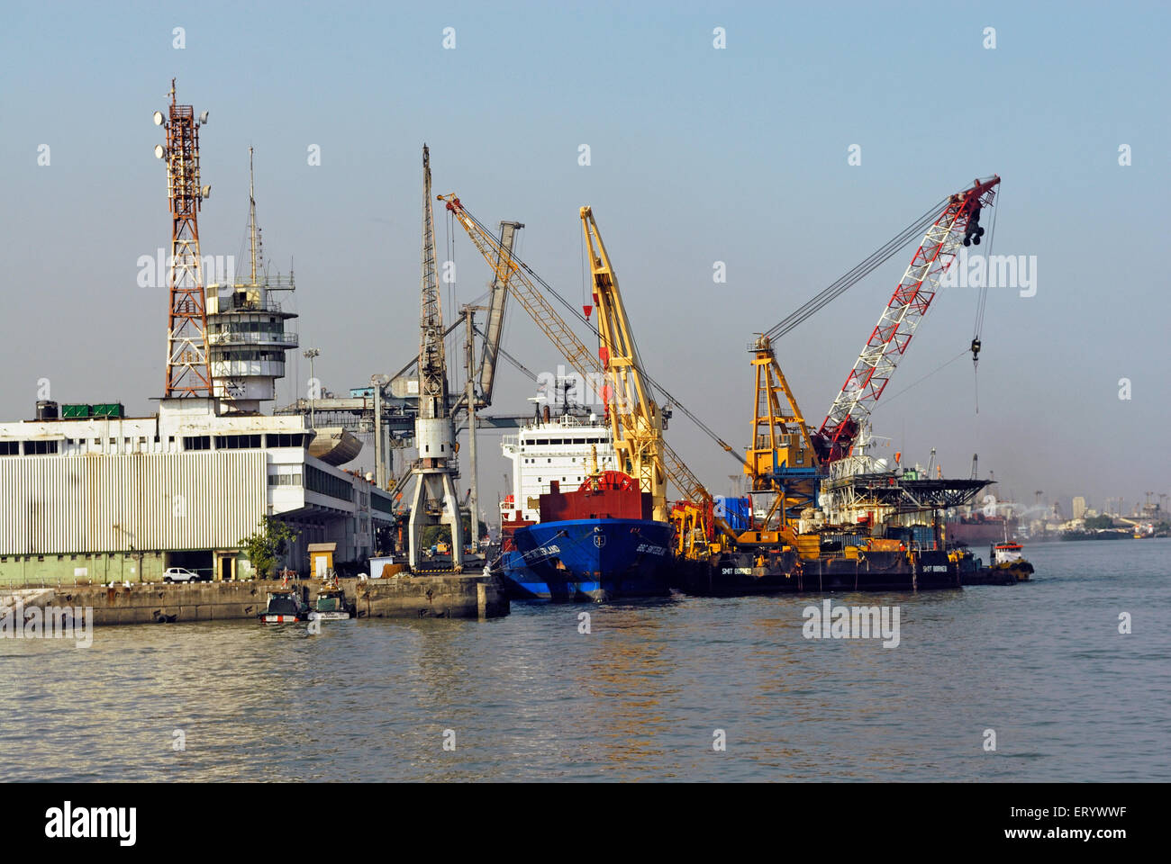 Huge cranes cargo ships on the Mumbai port trust ; Bombay ; Maharashtra ; India ; Indian shipping ; Asia ; Asian Stock Photo