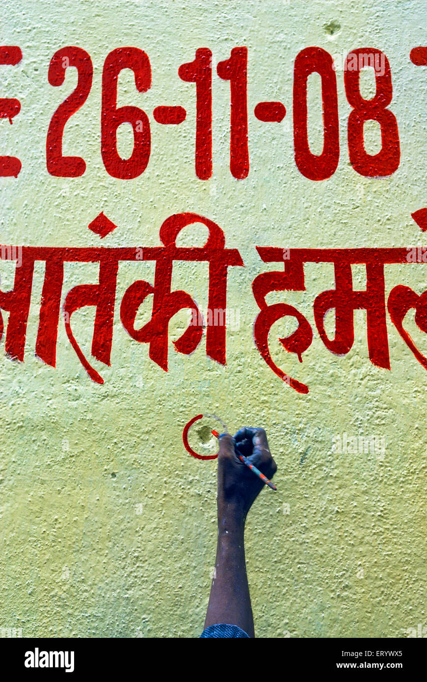 Painter encircle bullet marks on the wall ; Bombay ; Mumbai ; Maharashtra ; India Stock Photo