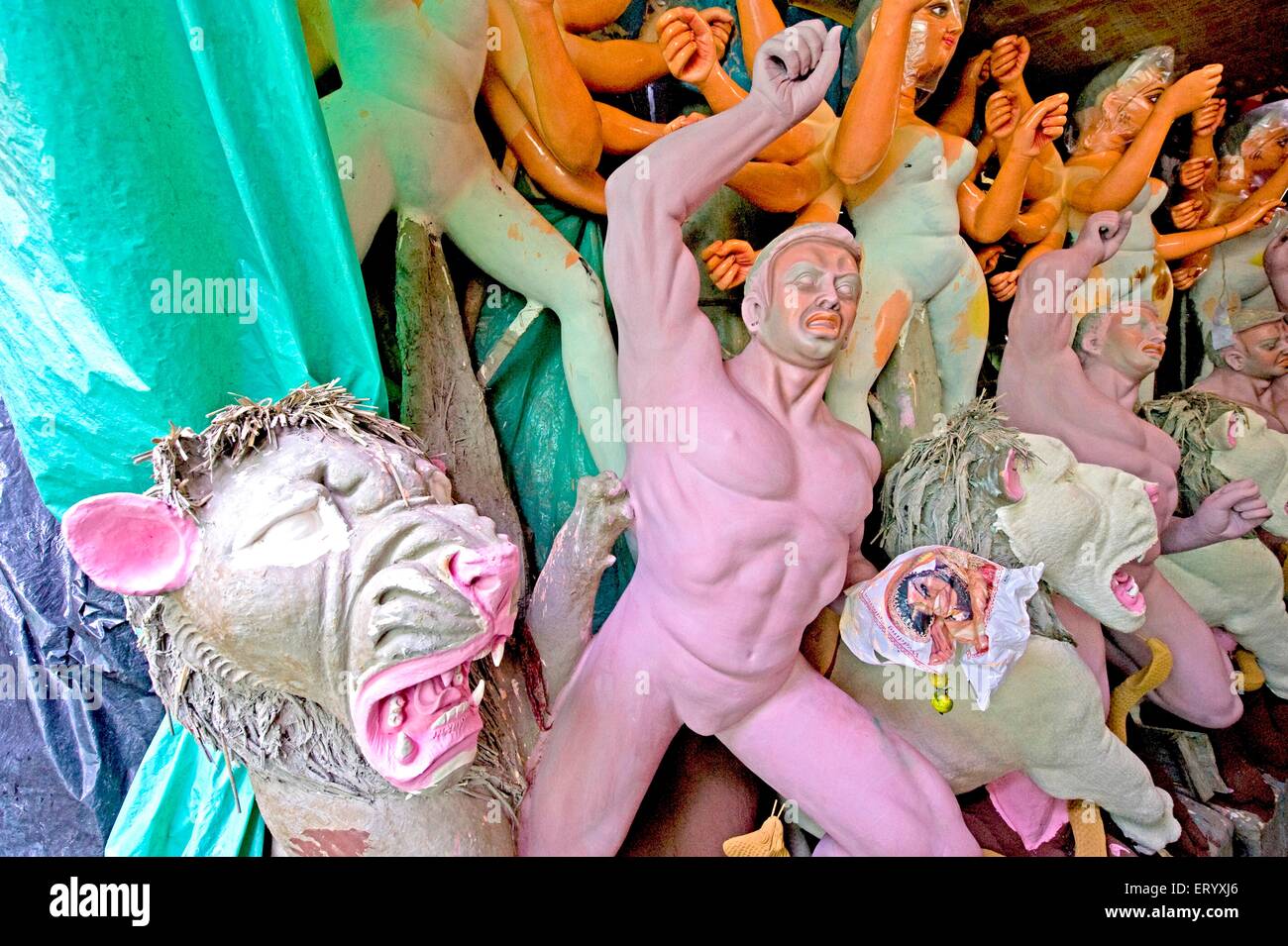 Clay models of goddess Durga rescuing demon from lions ; Kumartuli heritage artisan village of Calcutta ; West Bengal ; India Stock Photo