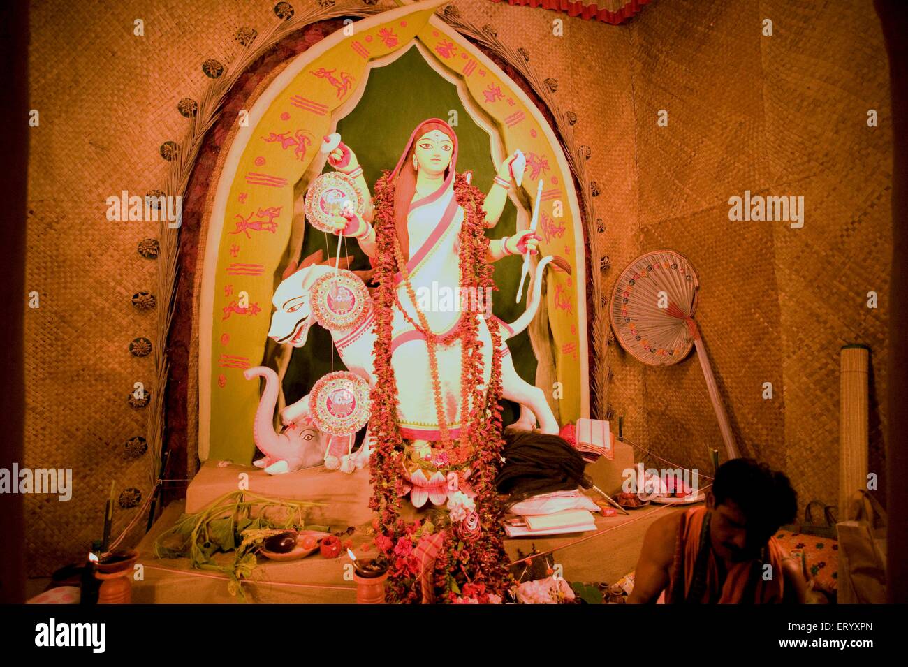 Mother goddess Durga in conventional Bengali sari and in midst of worshipping ; Calcutta ; West Bengal ; India Stock Photo
