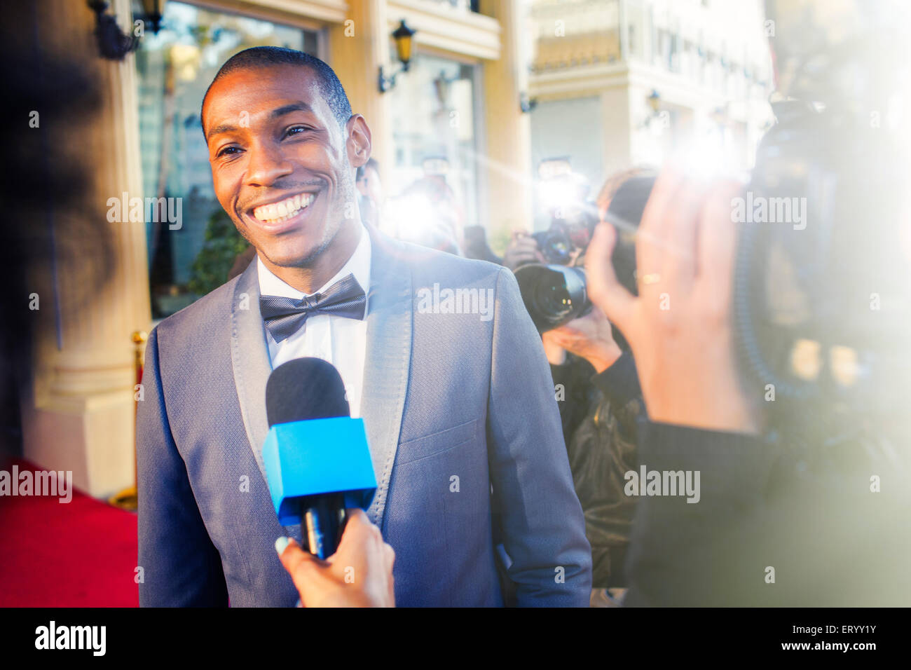 Celebrity being interviewed and photographed by paparazzi photographers Stock Photo
