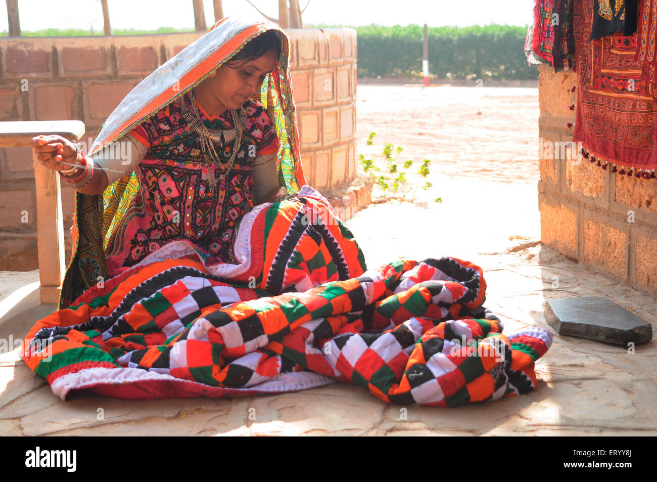 Lady sewing for sale in Hiralaxmi memorial park  ; Bhujodi  ; Bhuj  ; Kutch  ; Gujarat  ; India  MR#771L Stock Photo