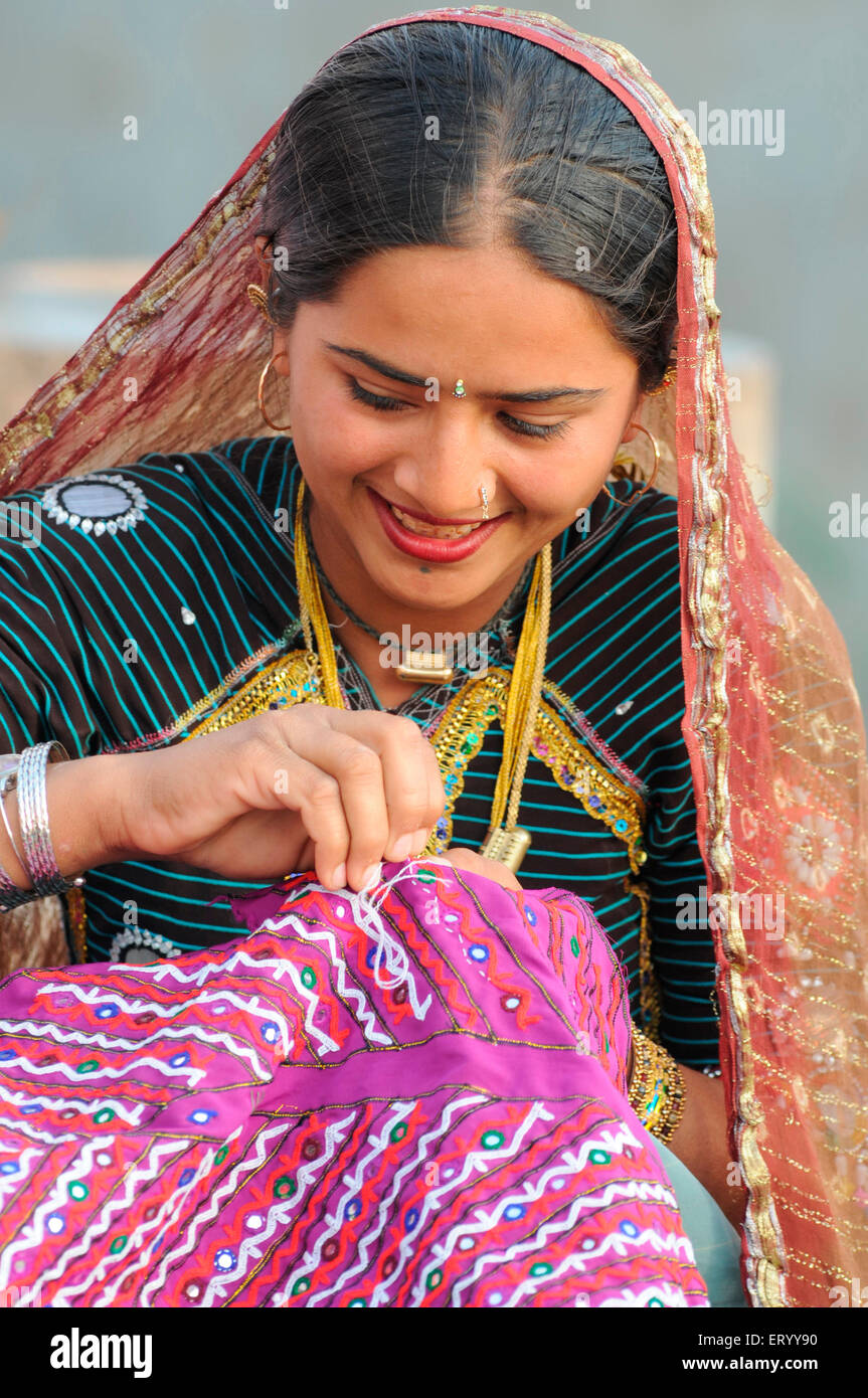 Rabari girl sewing  ;  Bhuj  ; Kutch  ; Gujarat  ; India  MR#771E Stock Photo