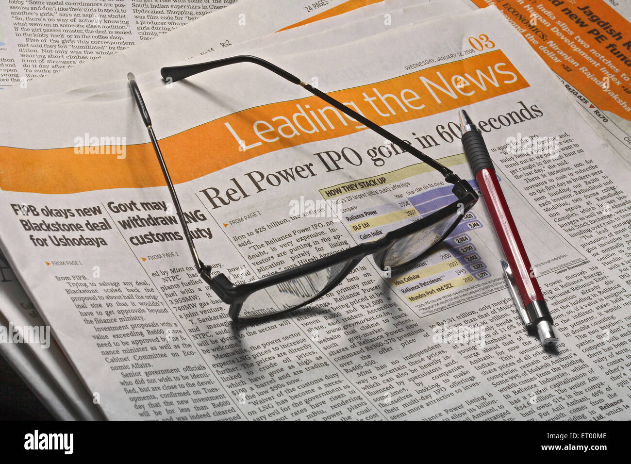 newspaper with glasses and pen Stock Photo Alamy