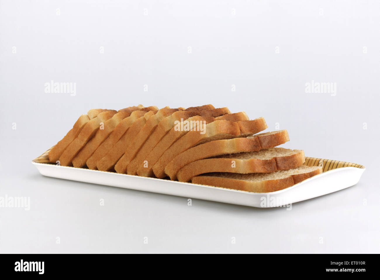 Sliced brown bread on white background Stock Photo - Alamy